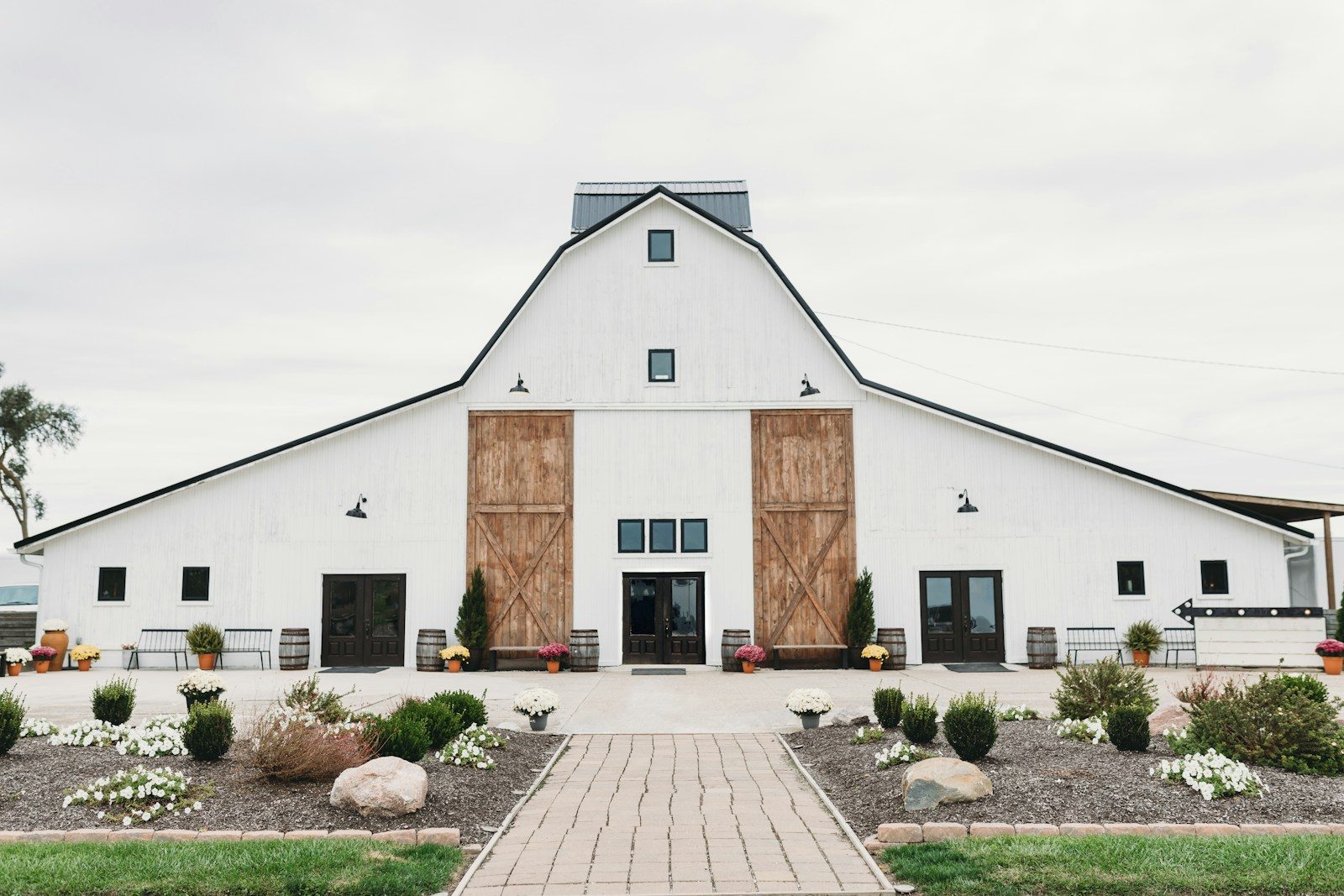 a white house with a brick driveway